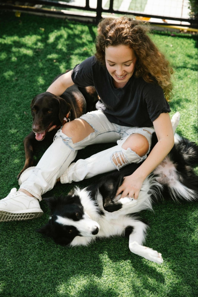 Woman playing with dogs