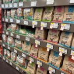 Natural pet food shelves with named protein sources at Mighty Pet in Menominee MI