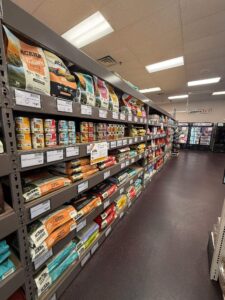 Pet food and supplies on shelves at Mighty Pet in Menominee MI